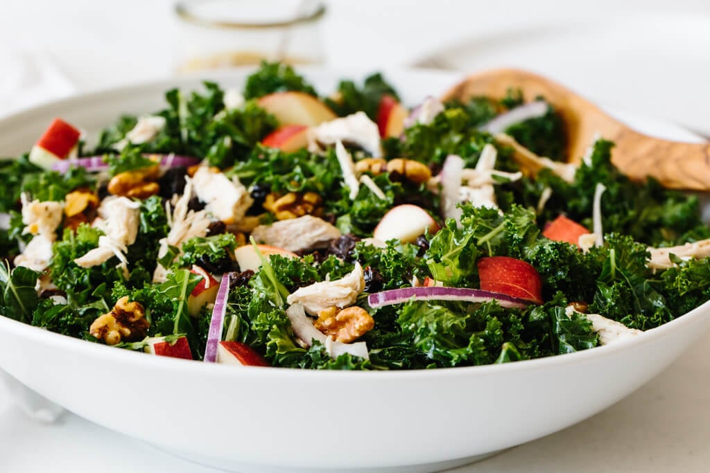 Kale salad with apples and chicken is bursting with autumn flavors in every single bite! Kale salad drizzled with apple cider vinaigrette.