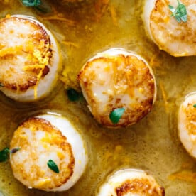 Close up of scallops in a pan.