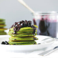 (gluten-free, paleo) Green Smoothie Pancakes with Macerated Blueberries. These light and fluffy pancakes get a health boost with blended spinach - that you can't taste.