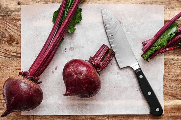 Slicing stems off beets before roasting