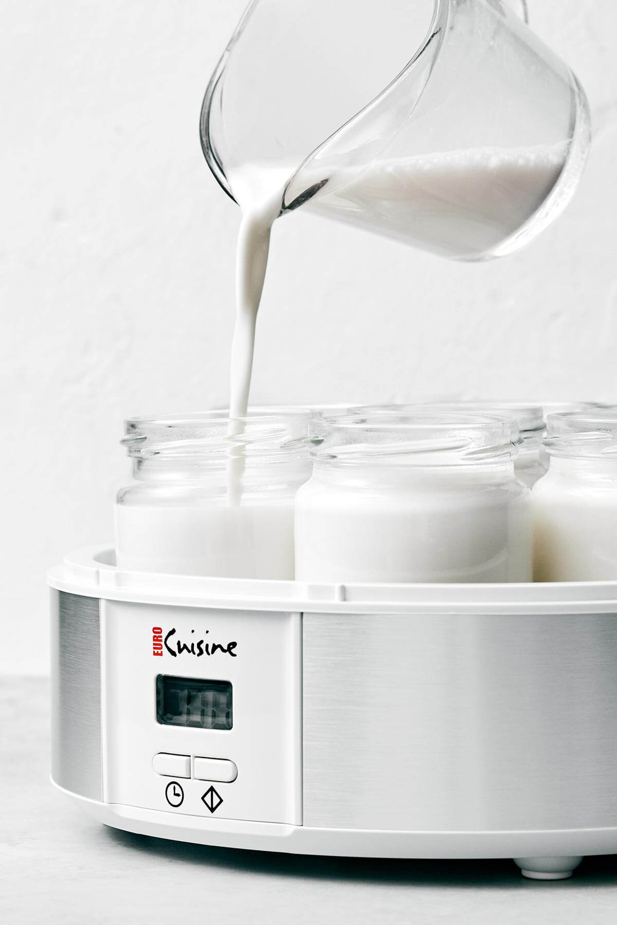 Making coconut yogurt in a yogurt maker.