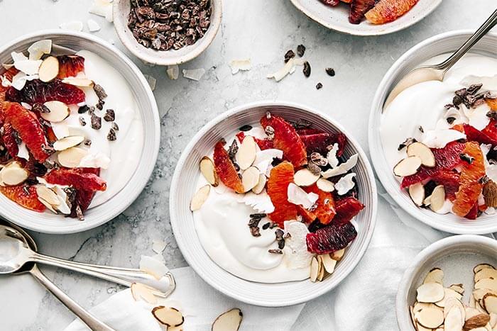 Bowls of coconut yogurt next to a napkin.