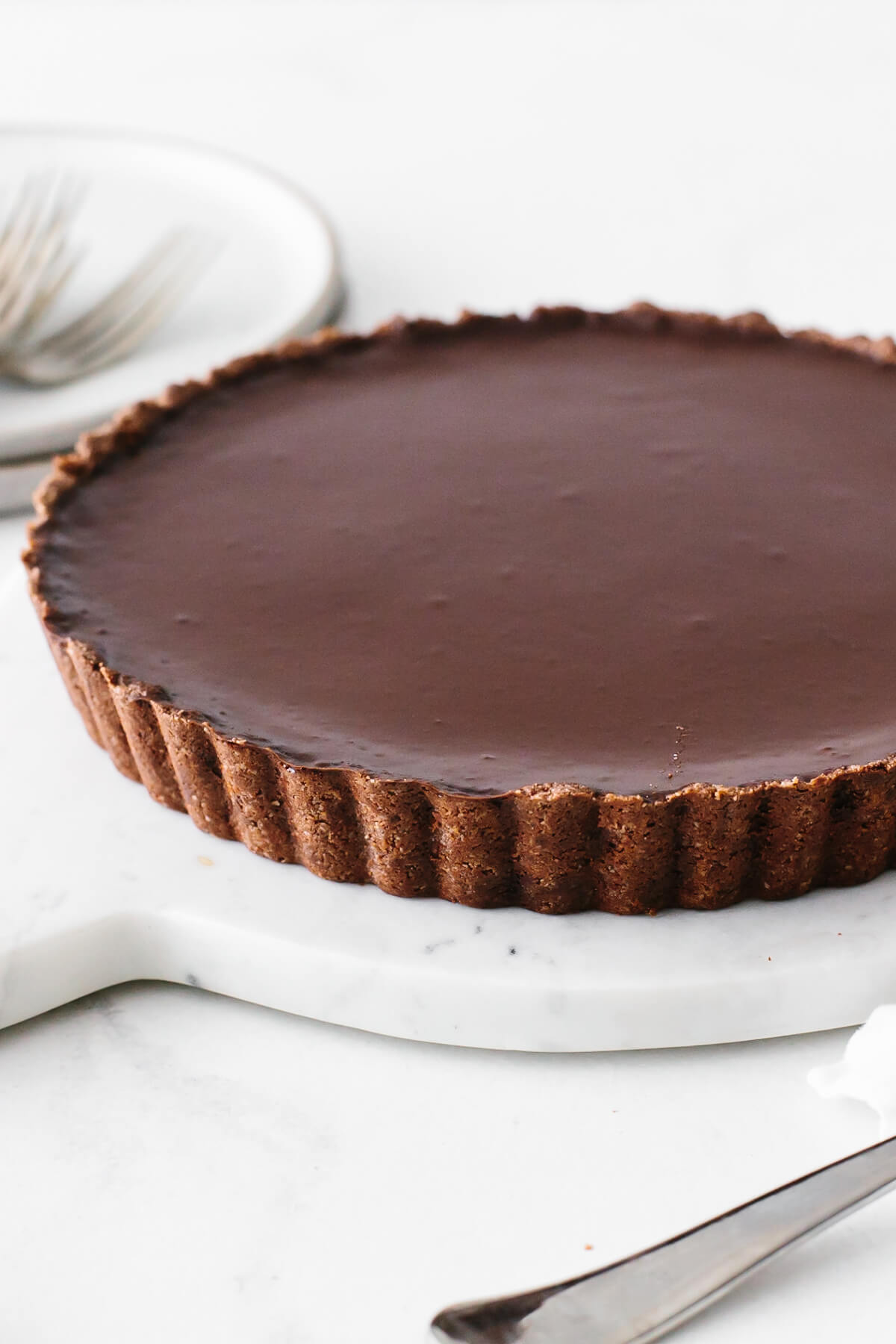 Chocolate tart recipe on a serving platter.