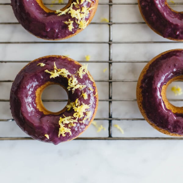 (gluten-free, paleo) Baked lemon donuts with blackberry glaze.