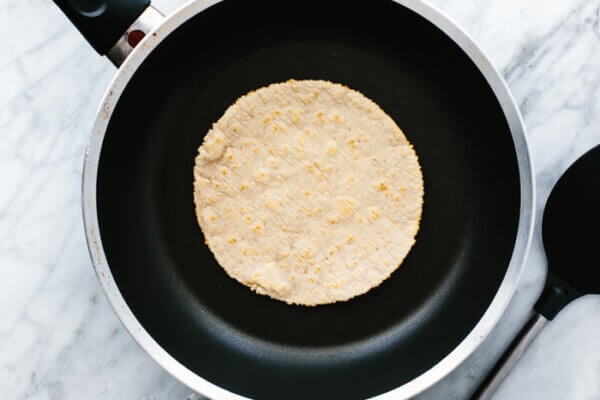 Frying a cassava flour tortilla in a pan