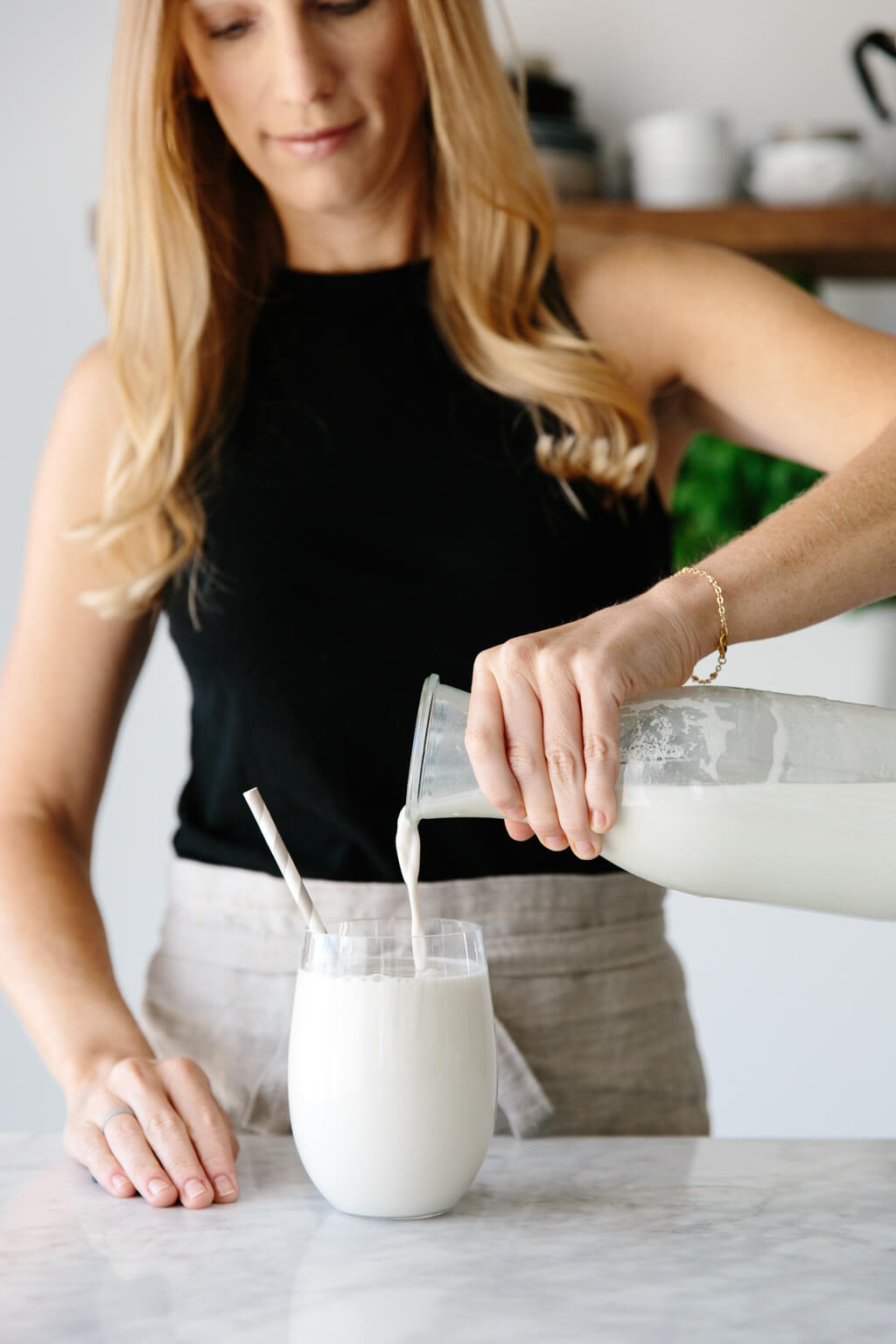 Cashew milk is a delicious and creamy dairy-free vegan nut milk. And unlike almond milk it doesn't have to be strained, which makes it even easier! Cashew milk being poured into a glass