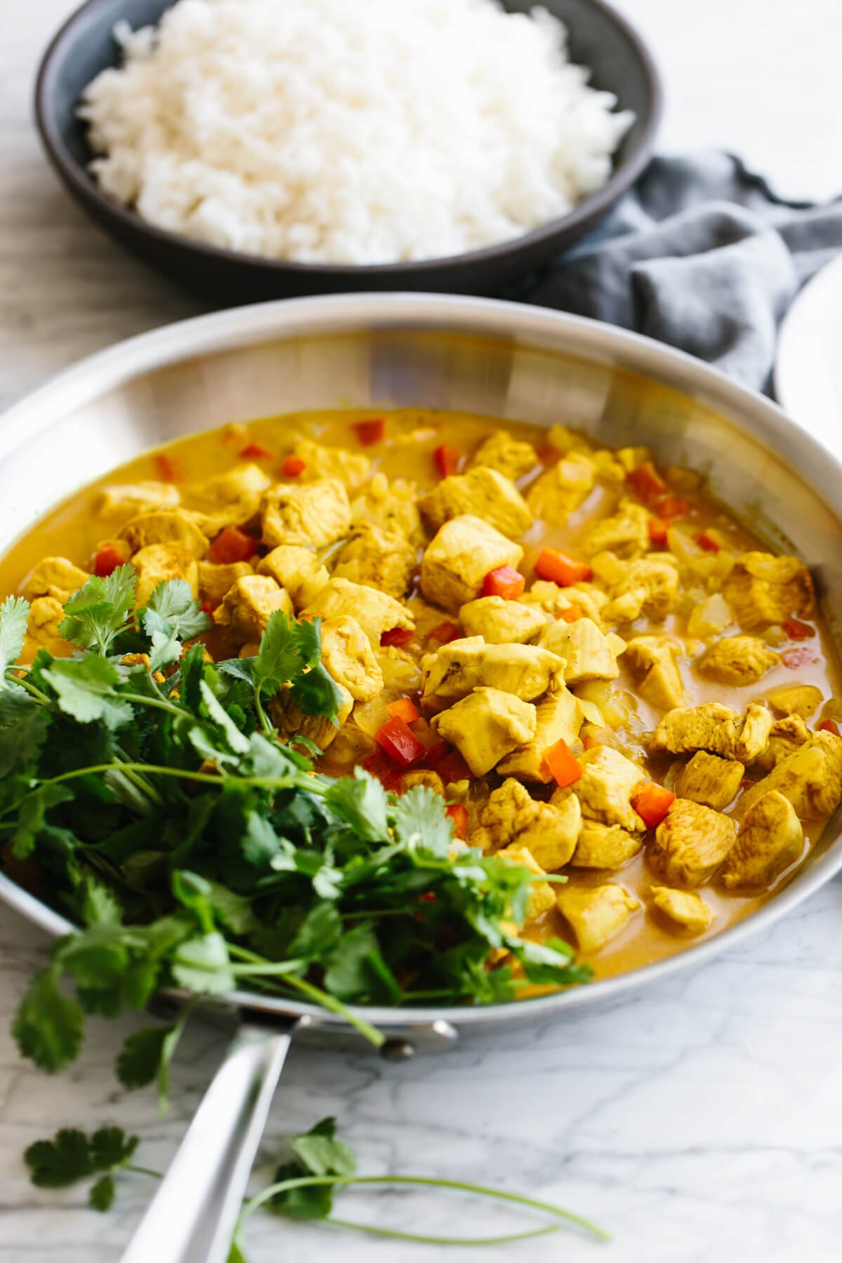 Coconut curry chicken is an easy, healthy, one-pan, weeknight dinner recipe that's packed with flavor! Coconut curry chicken in a pan with cilantro.