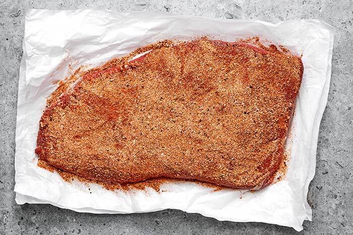Brisket with dry rub on it.