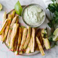 Baked yuca fries (also known as cassava fries) are golden and crispy on the outside and soft on the inside. They're a healthier way to make yuca fries and I'm serving them up with cilantro lime mayonnaise. 