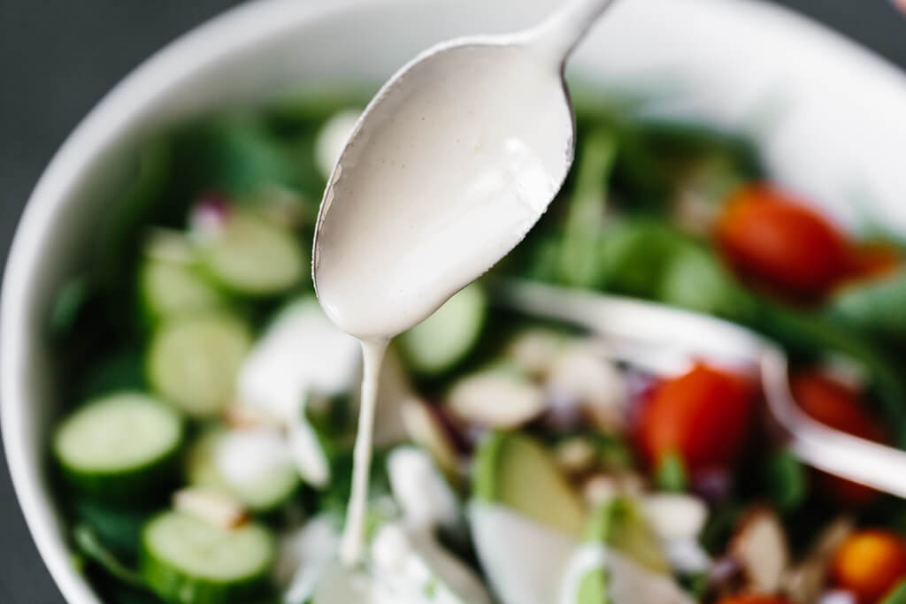 This lemon tahini dressing is oil-free, dairy-free and vegan. It's a tasty, creamy, zesty salad dressing that's super versatile and adaptable. #LemonTahiniDressing #Tahini