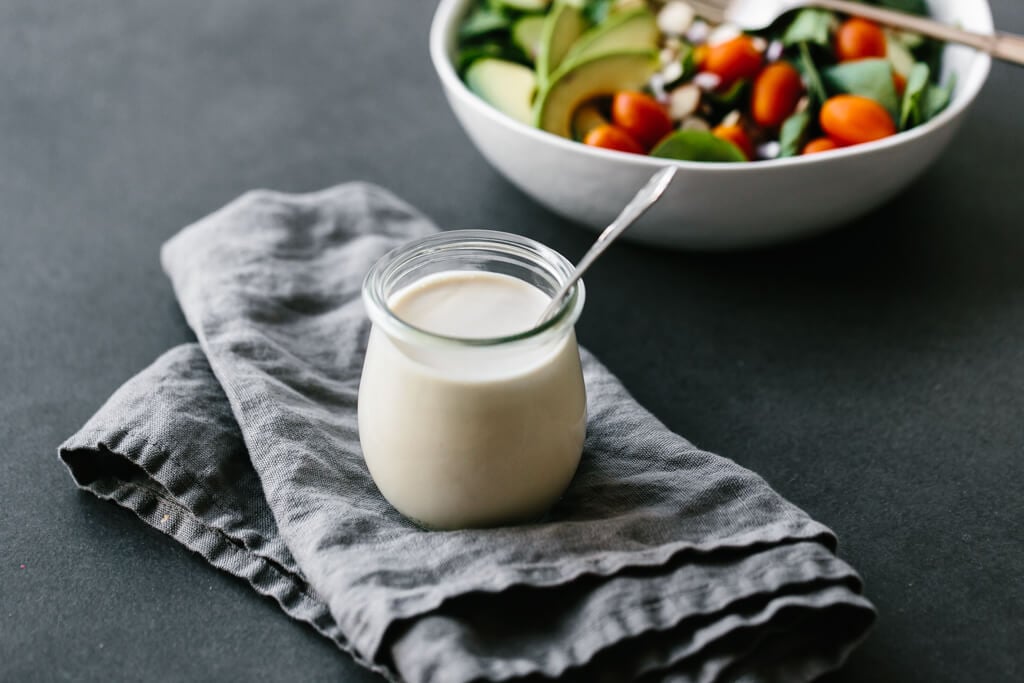 This lemon tahini dressing is oil-free, dairy-free and vegan. It's a tasty, creamy, zesty salad dressing that's super versatile and adaptable. #LemonTahiniDressing #Tahini