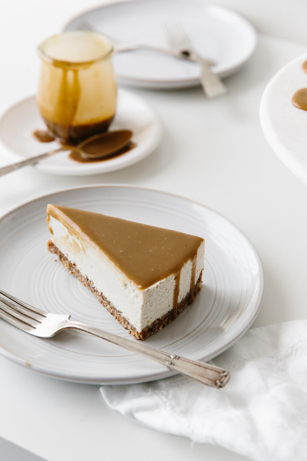 This gluten-free Vegan Caramel Cheesecake recipe is drizzled with the most amazing salted caramel sauce. The vegan cheesecake is simply made from cashews that have soaked overnight and it's super creamy and decadent.