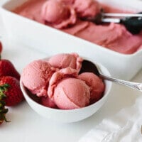 Strawberry frozen yogurt scooped into a white bowl.