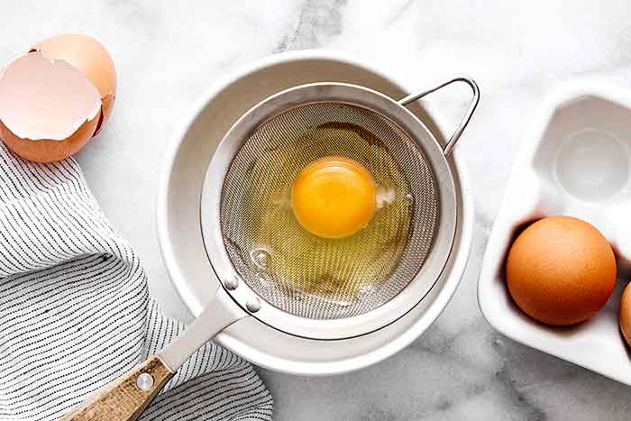 Step one of poached eggs: Crack the egg.