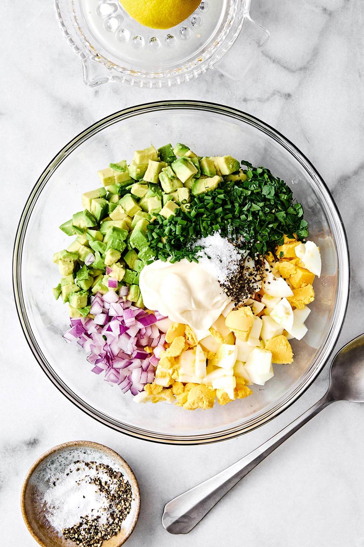 This avocado egg salad is a healthy twist on your classic egg salad with creamy avocado and fresh herbs—a salad recipe you'll love! Avocado egg salad ingredients in a bowl.