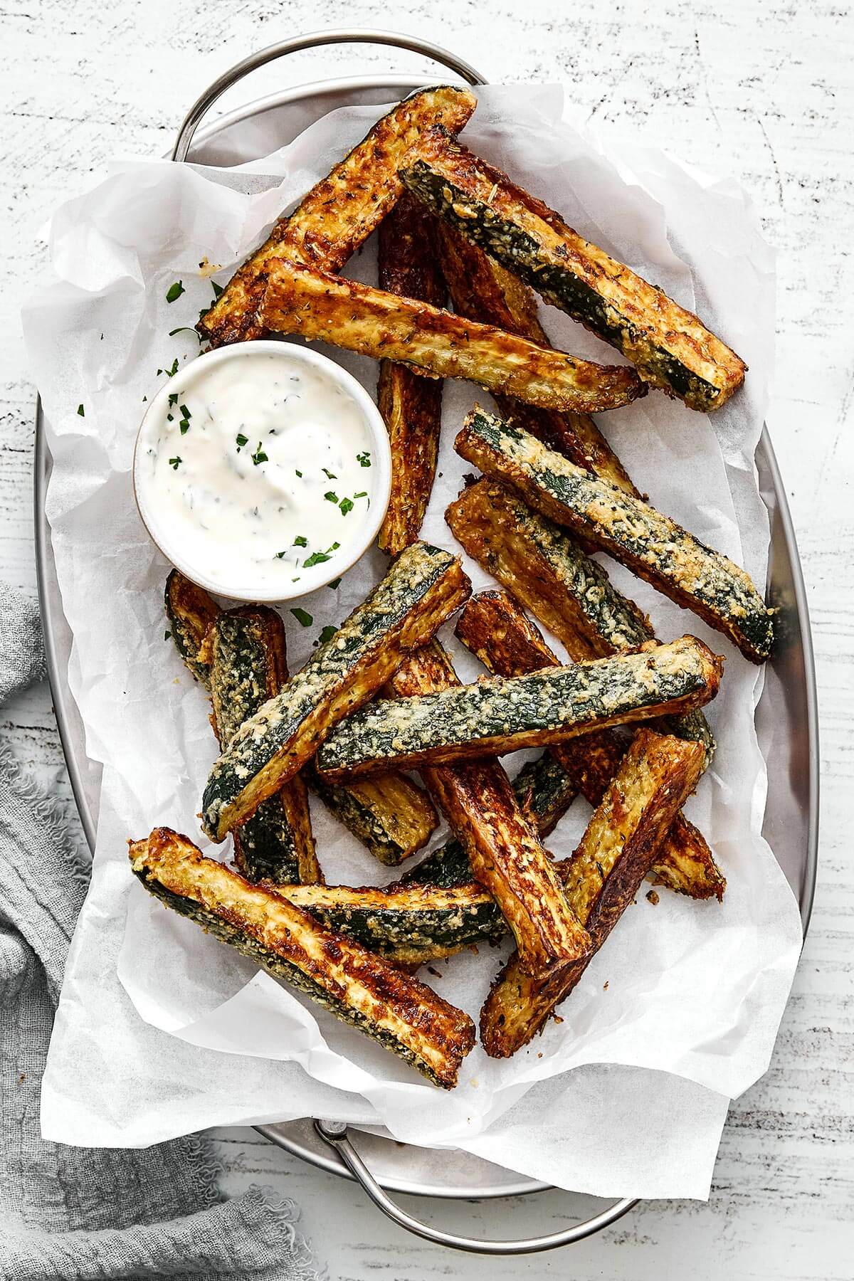 Baked zucchini fries in a platter.