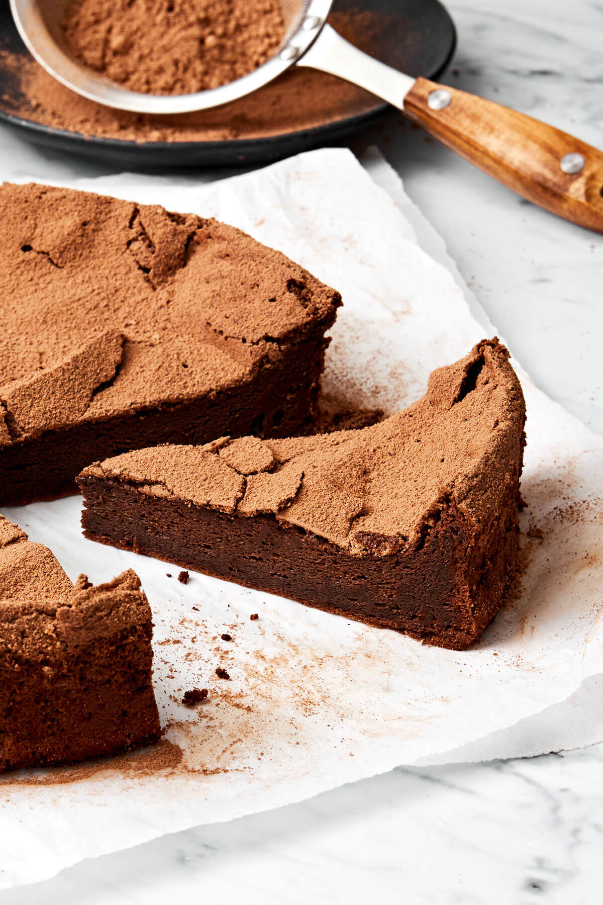 This flourless chocolate cake is a deliciously elegant yet easy chocolate dessert that’s sure to impress guests. A slice of flourless chocolate cake.