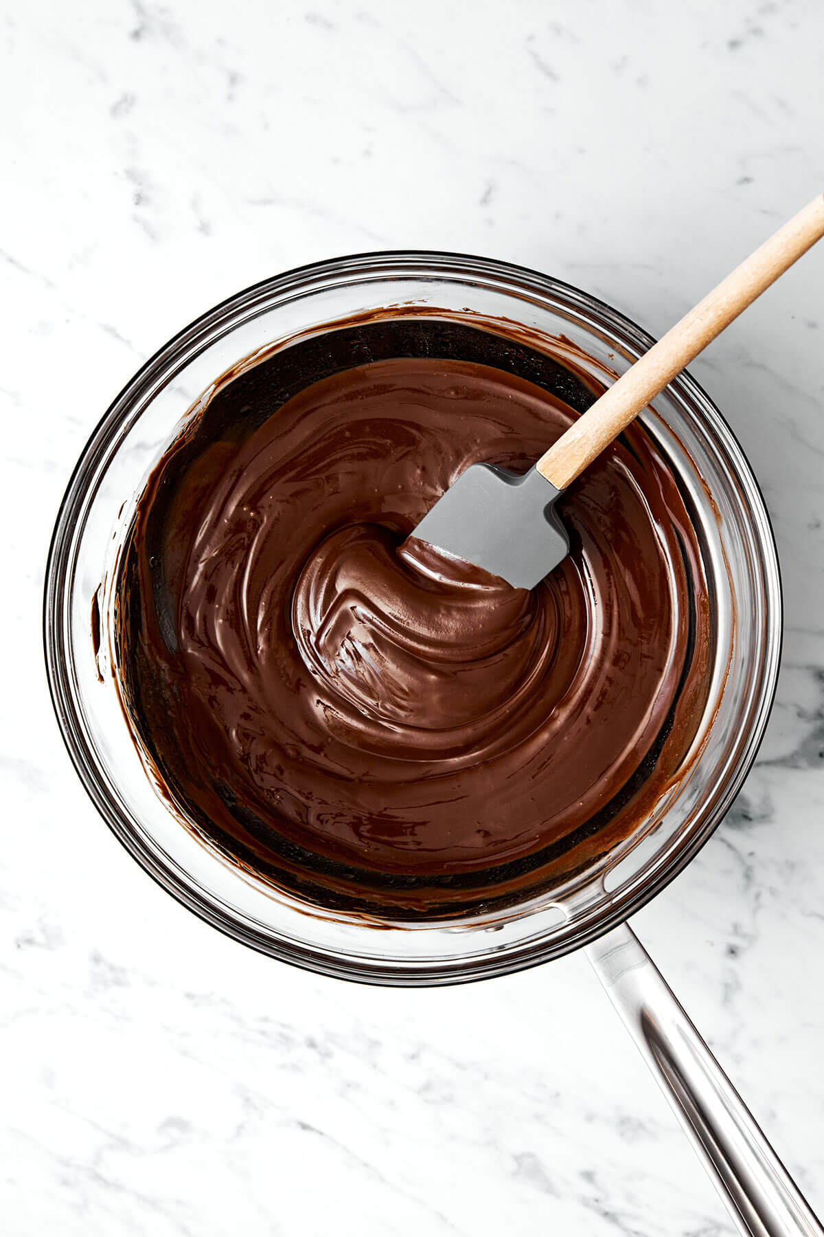 This flourless chocolate cake is a deliciously elegant yet easy chocolate dessert that’s sure to impress guests. Melted chocolate in a bowl.