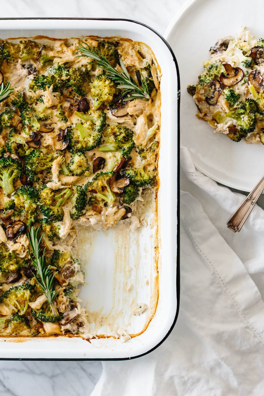 Whole30 casserole recipe with shredded chicken, sautéed mushrooms and broccoli, then topped with my Vegan Alfredo Sauce for an easy and healthy weeknight dinner. It's also a dairy-free and paleo casserole recipe.