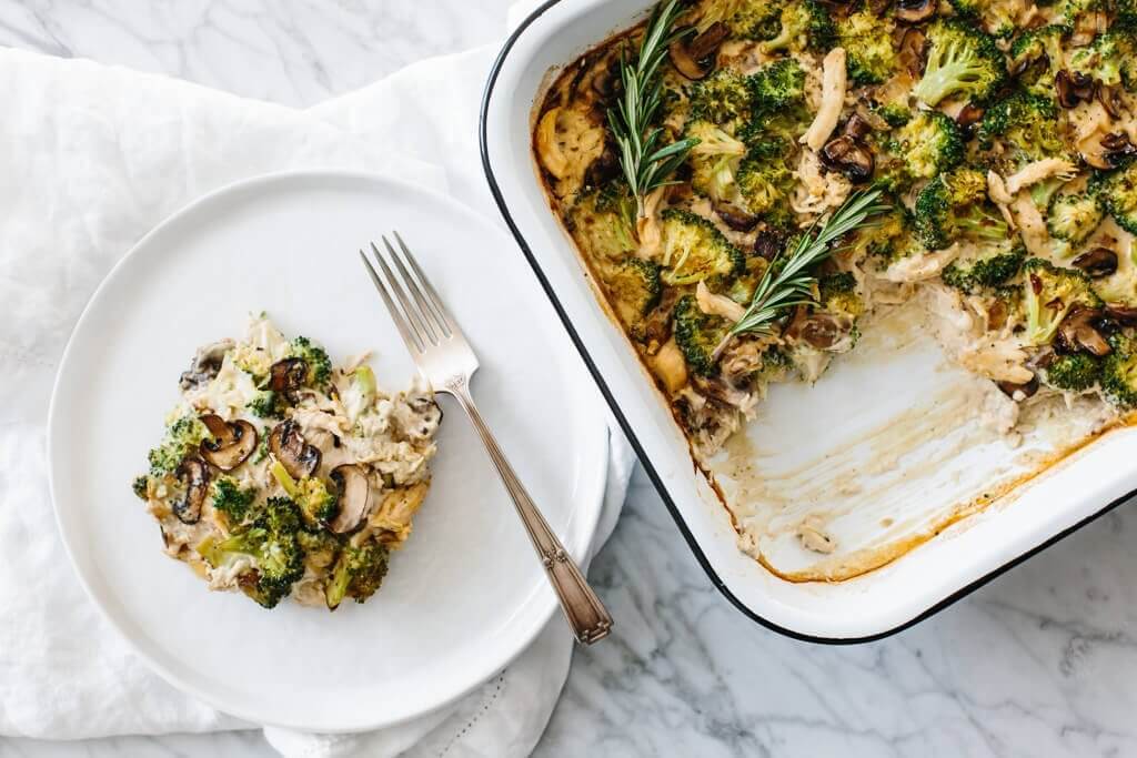 Whole30 casserole recipe with shredded chicken, sautéed mushrooms and broccoli, then topped with my Vegan Alfredo Sauce for an easy and healthy weeknight dinner. It's also a dairy-free and paleo casserole recipe.