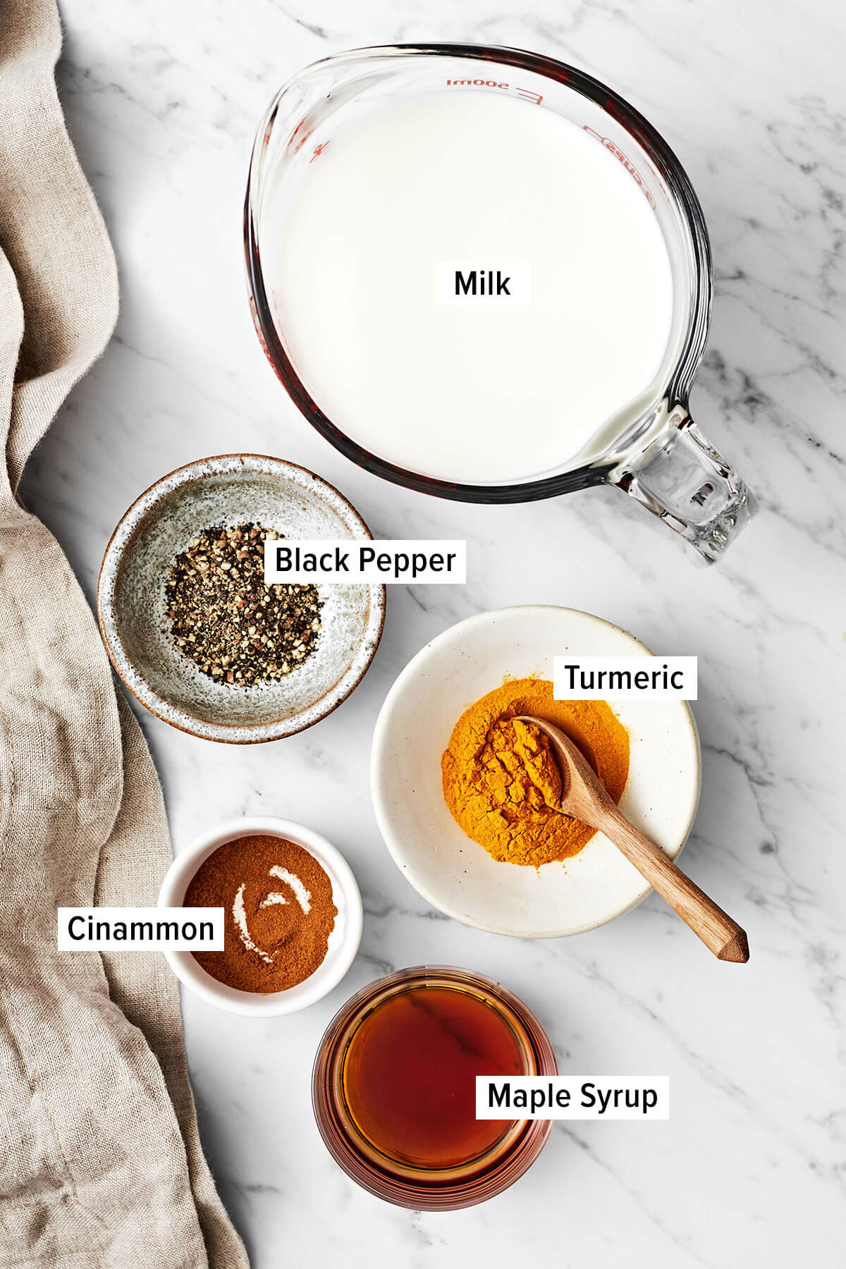 Golden milk (turmeric milk) reigns supreme for a healthy, healing, and anti-inflammatory drink! Bonus — it's super delicious. Ingredients for golden turmeric milk on a table