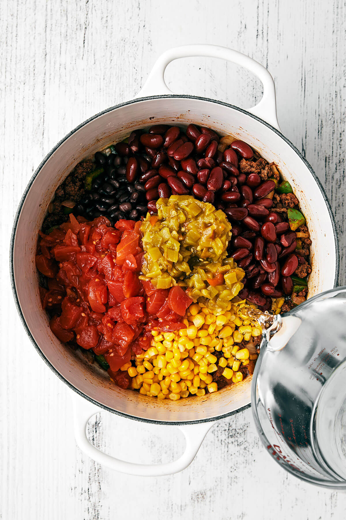 Cooking beans and meat in a pot