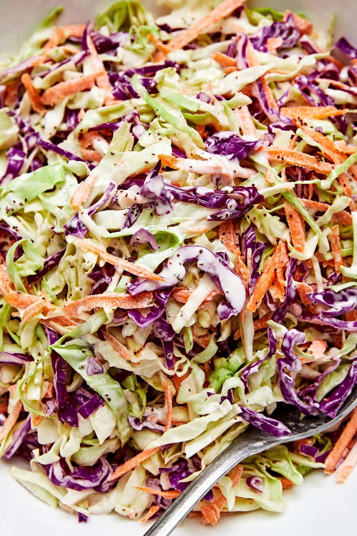 This easy coleslaw recipe is perfect for summer BBQ's and potlucks, whether it's served as a side dish or layered in pulled pork sliders! Coleslaw in a bowl.