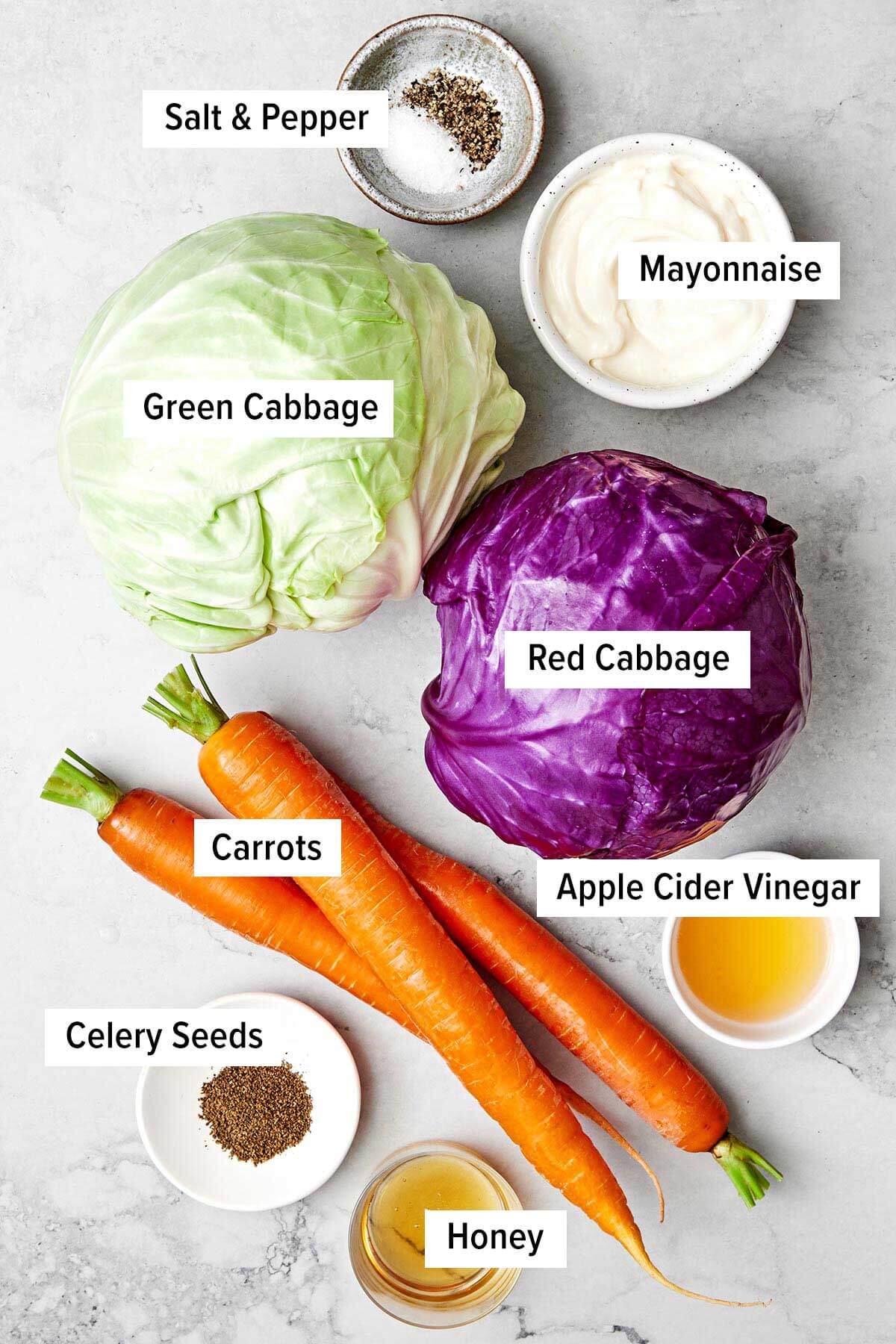 This easy coleslaw recipe is perfect for summer BBQ's and potlucks, whether it's served as a side dish or layered in pulled pork sliders! Ingredients for coleslaw on a table.