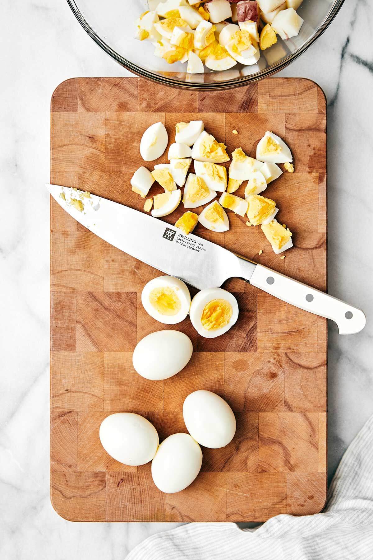 Diced eggs on a wooden board.