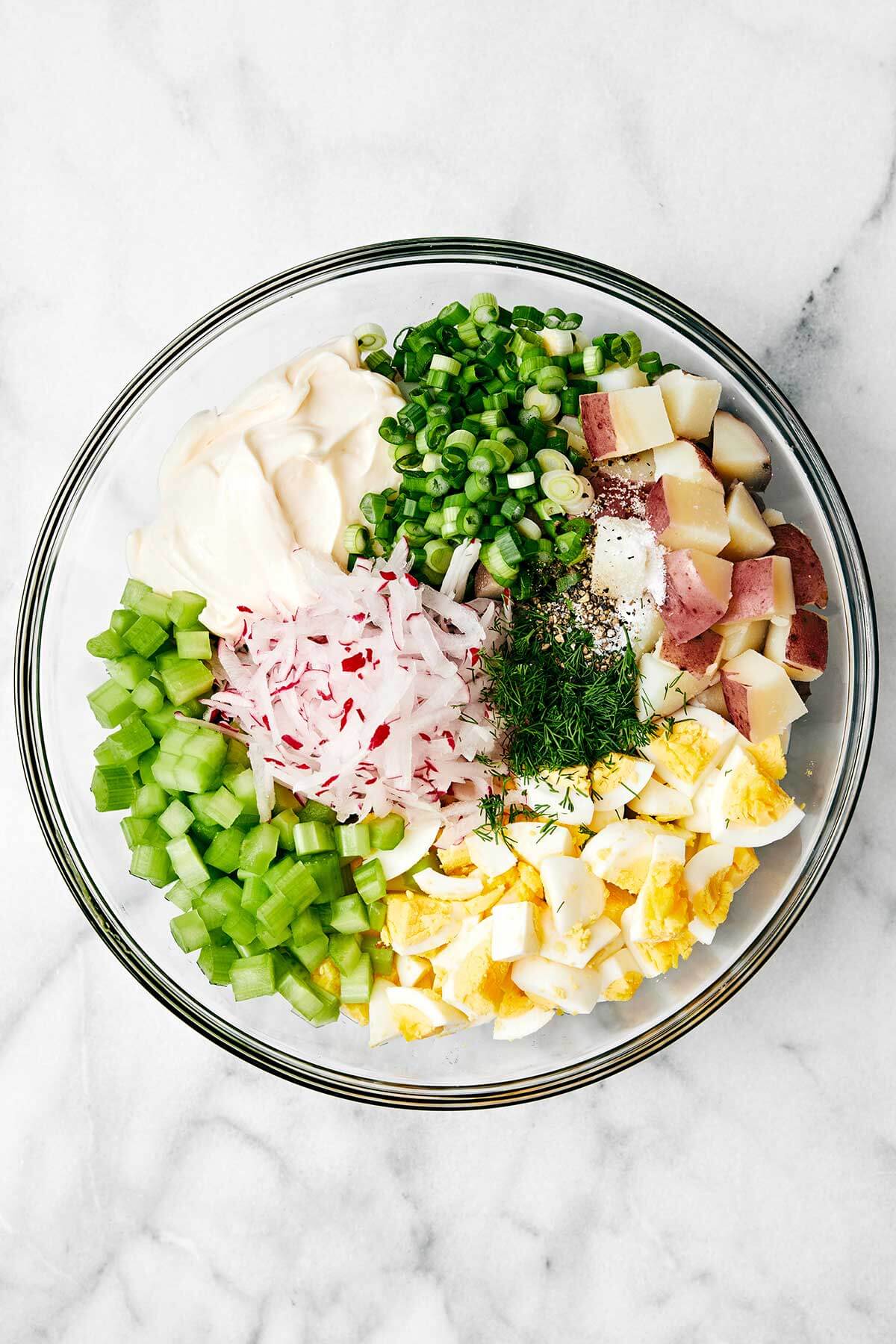 Potato salad ingredients in a bowl.