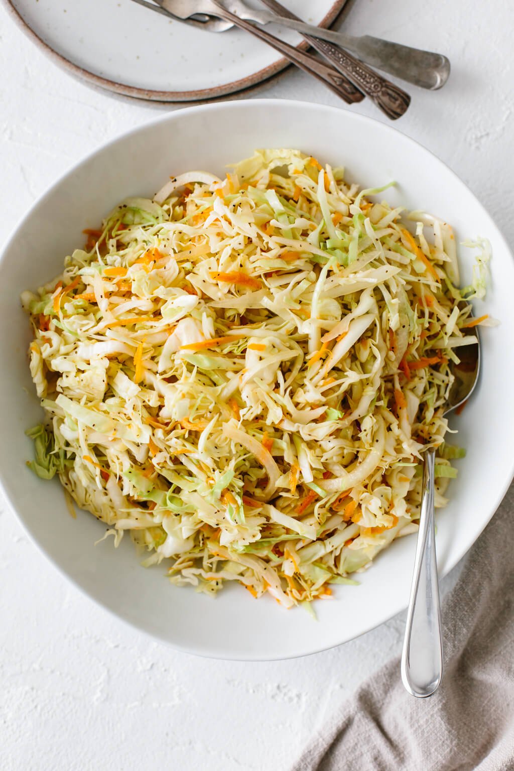 Vinegar based coleslaw in a white bowl.