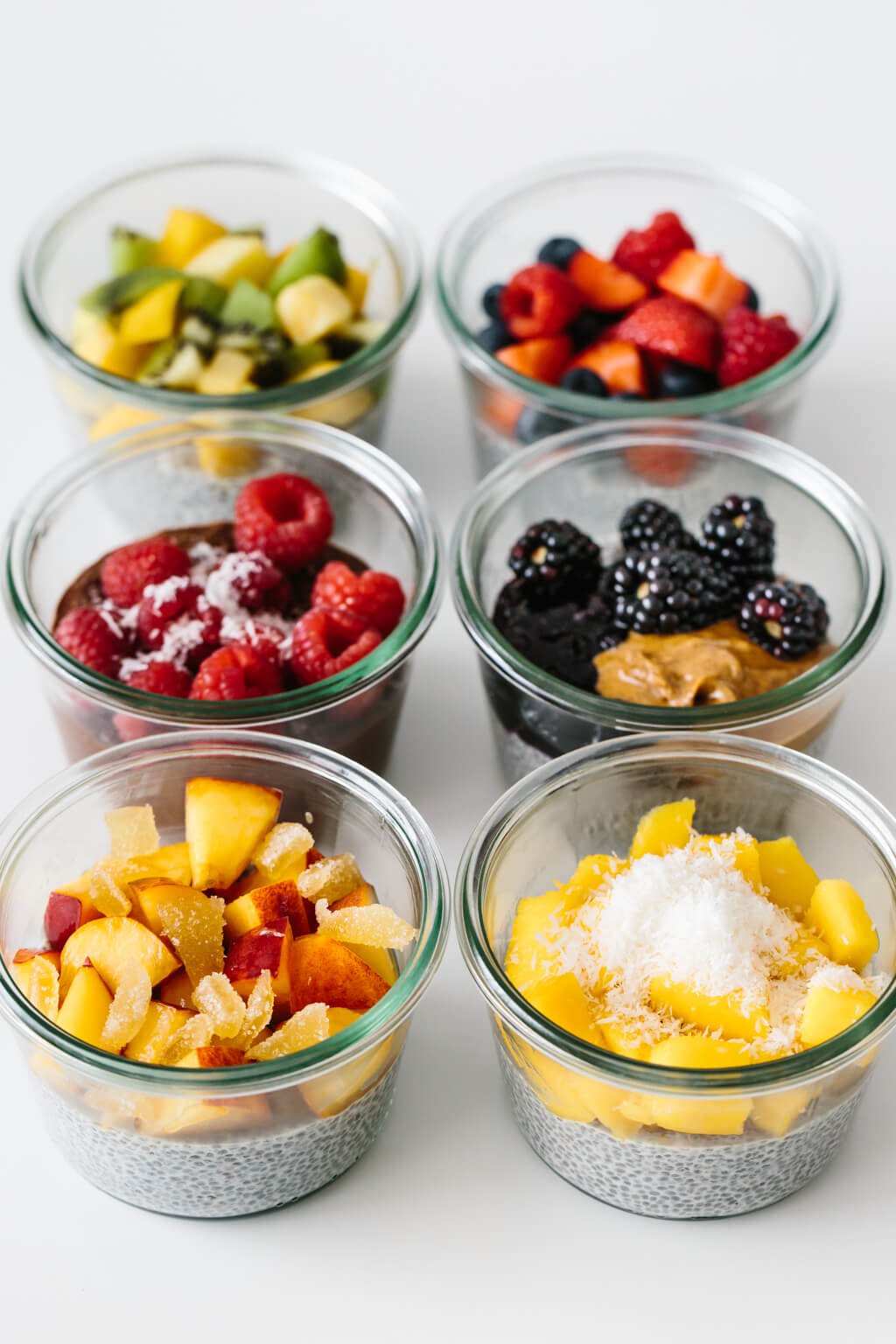 Chia pudding meal prepped with fresh fruit in glass containers.