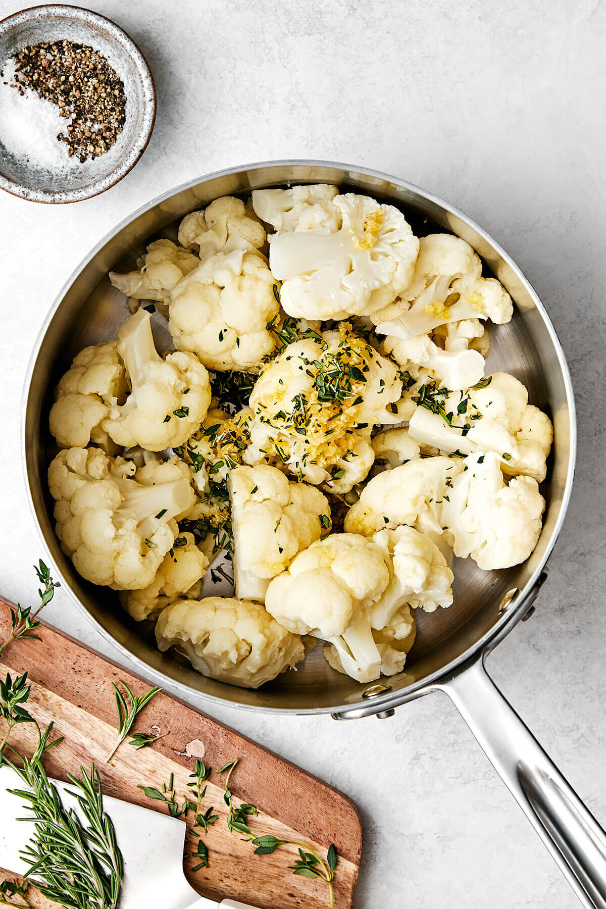 This mashed cauliflower is a fabulous low-carb side dish for weeknight dinners. It's delicious, creamy, flavorful, and quick to make! Making mashed cauliflower in a pot.