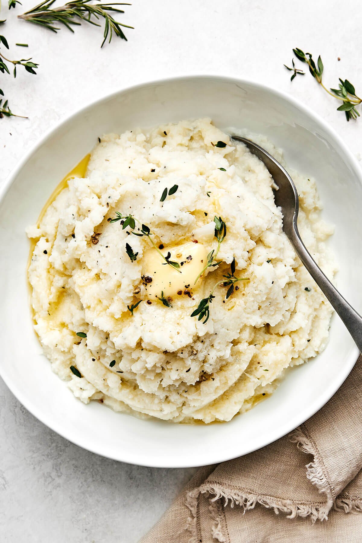 This mashed cauliflower is a fabulous low-carb side dish for weeknight dinners. It's delicious, creamy, flavorful, and quick to make! A bowl of mashed cauliflower