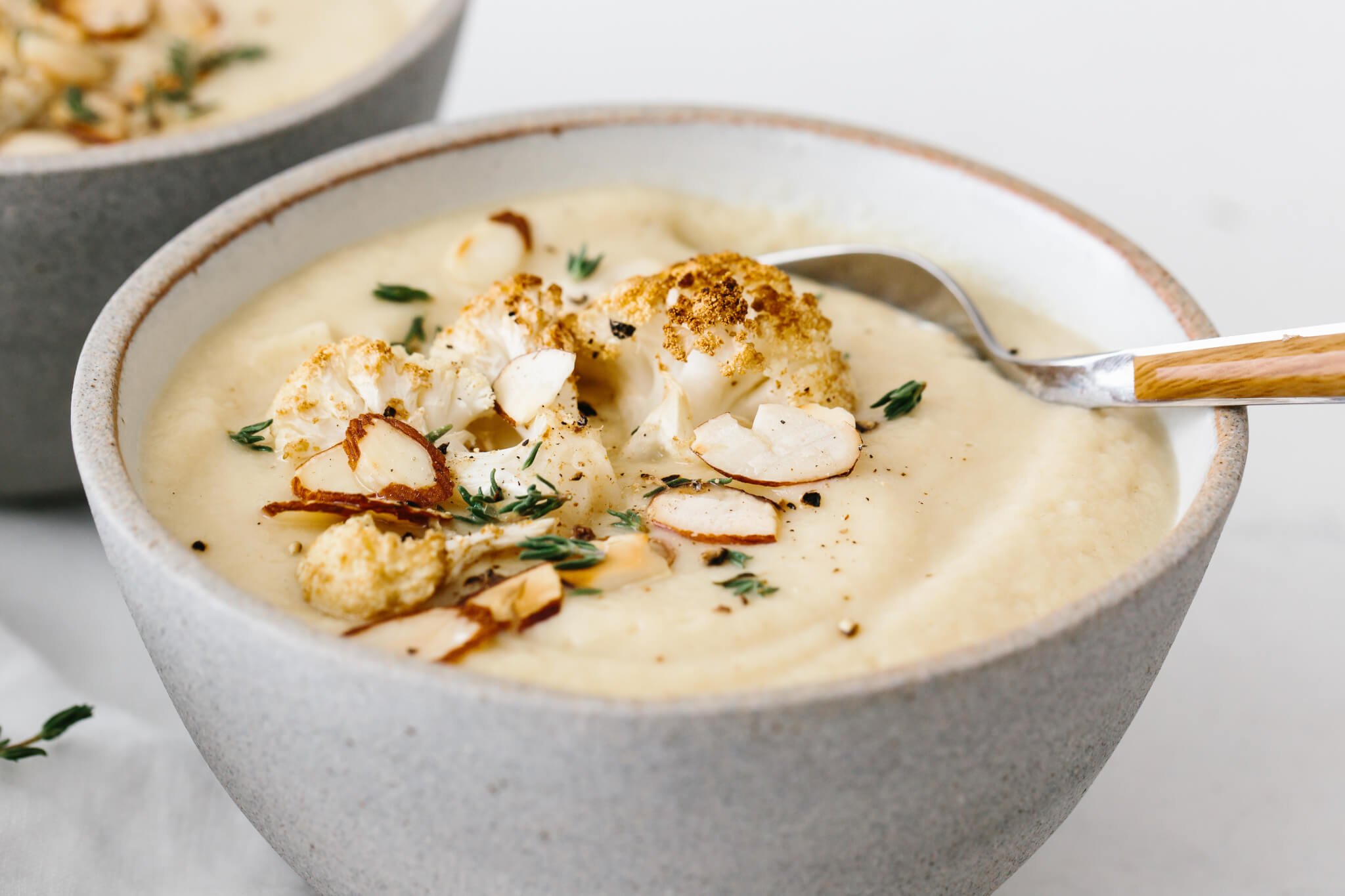 Close up photo of roasted cauliflower soup toppings.