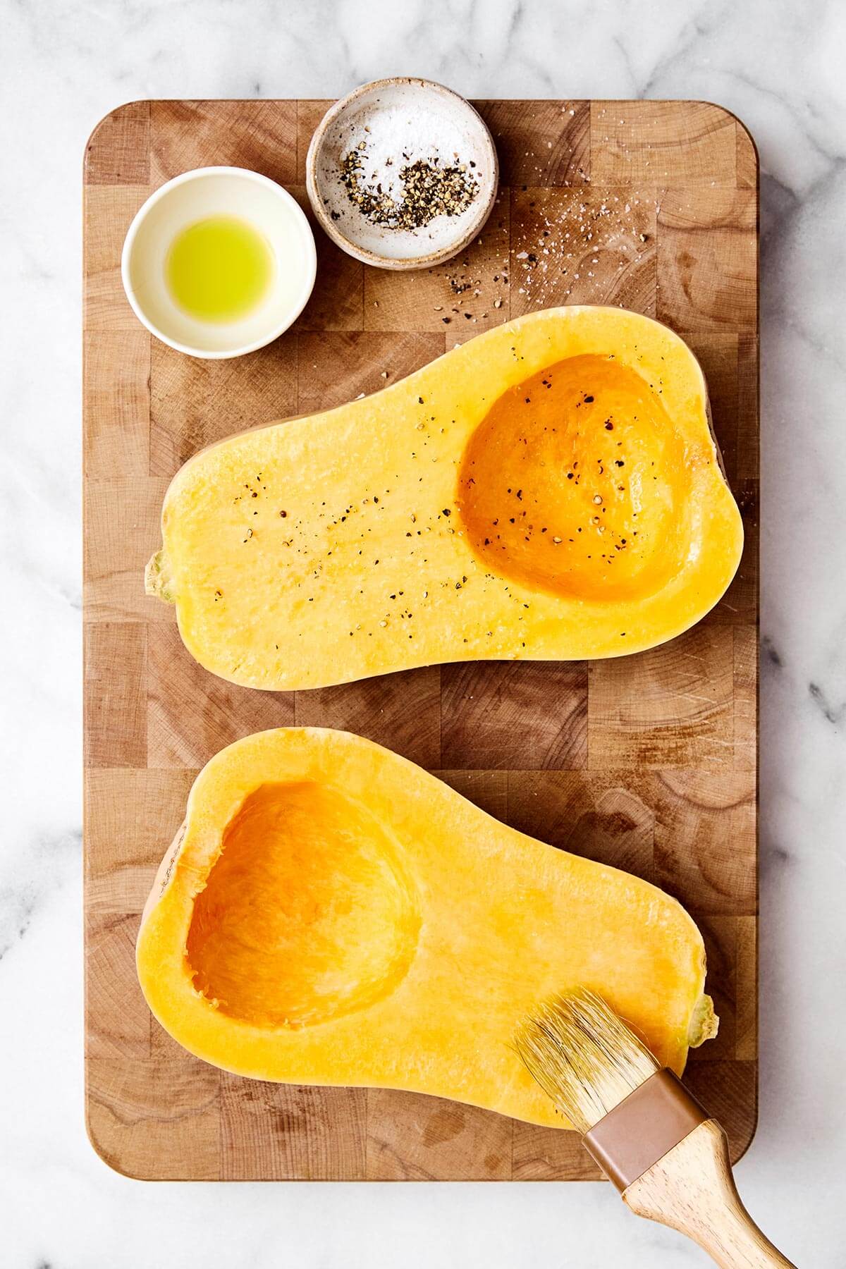 Seasoned butternut squash halves.