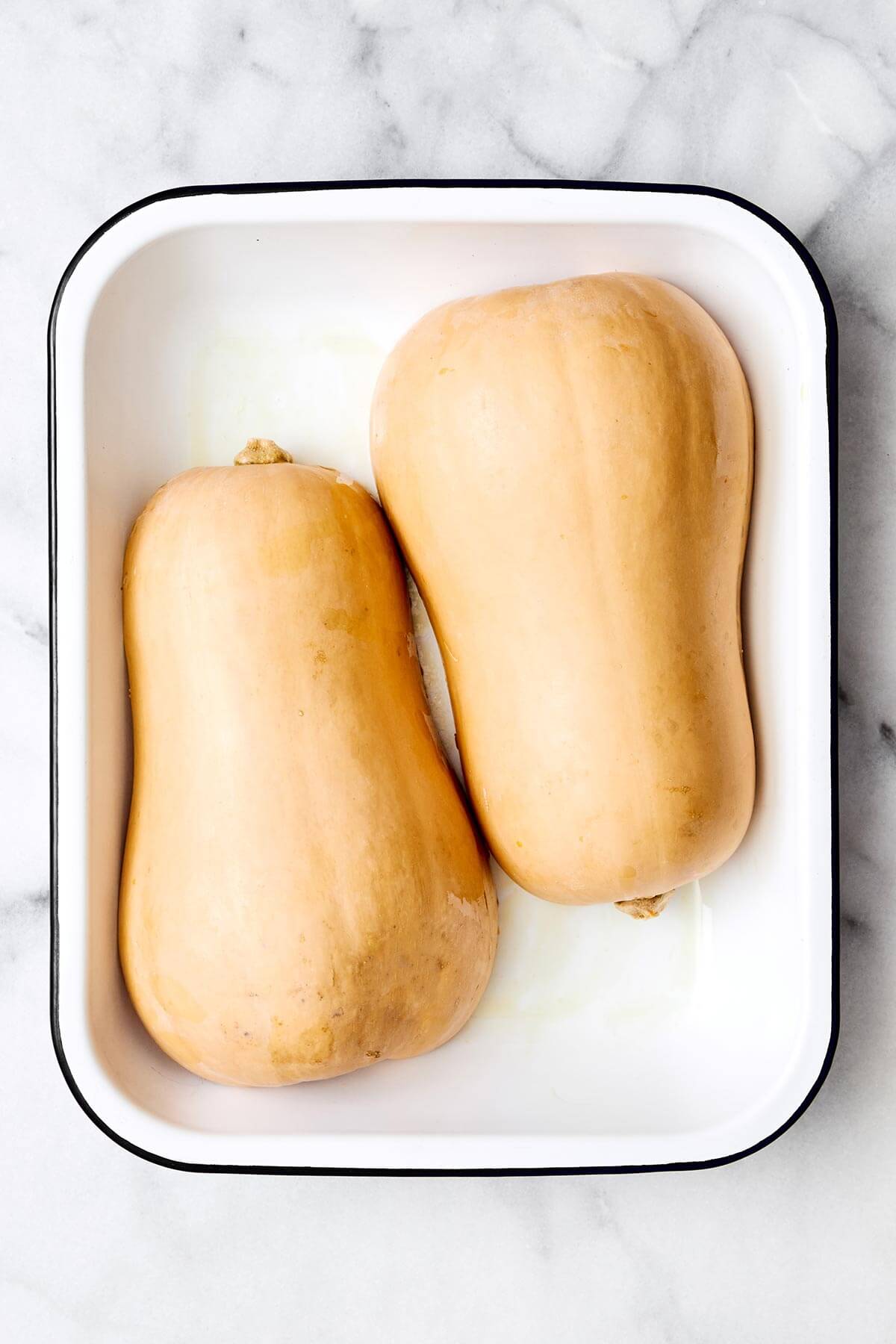 Baking butternut squash halves.
