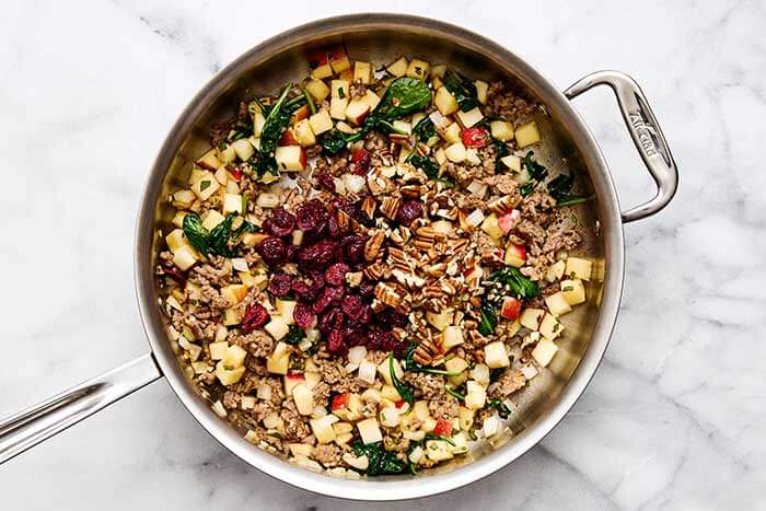 Apple sausage filling in a pan.