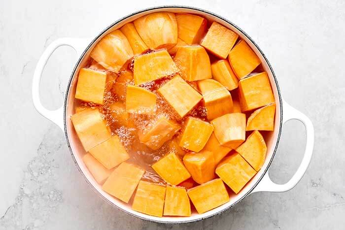 A pot of water with boiled sweet potatoes.