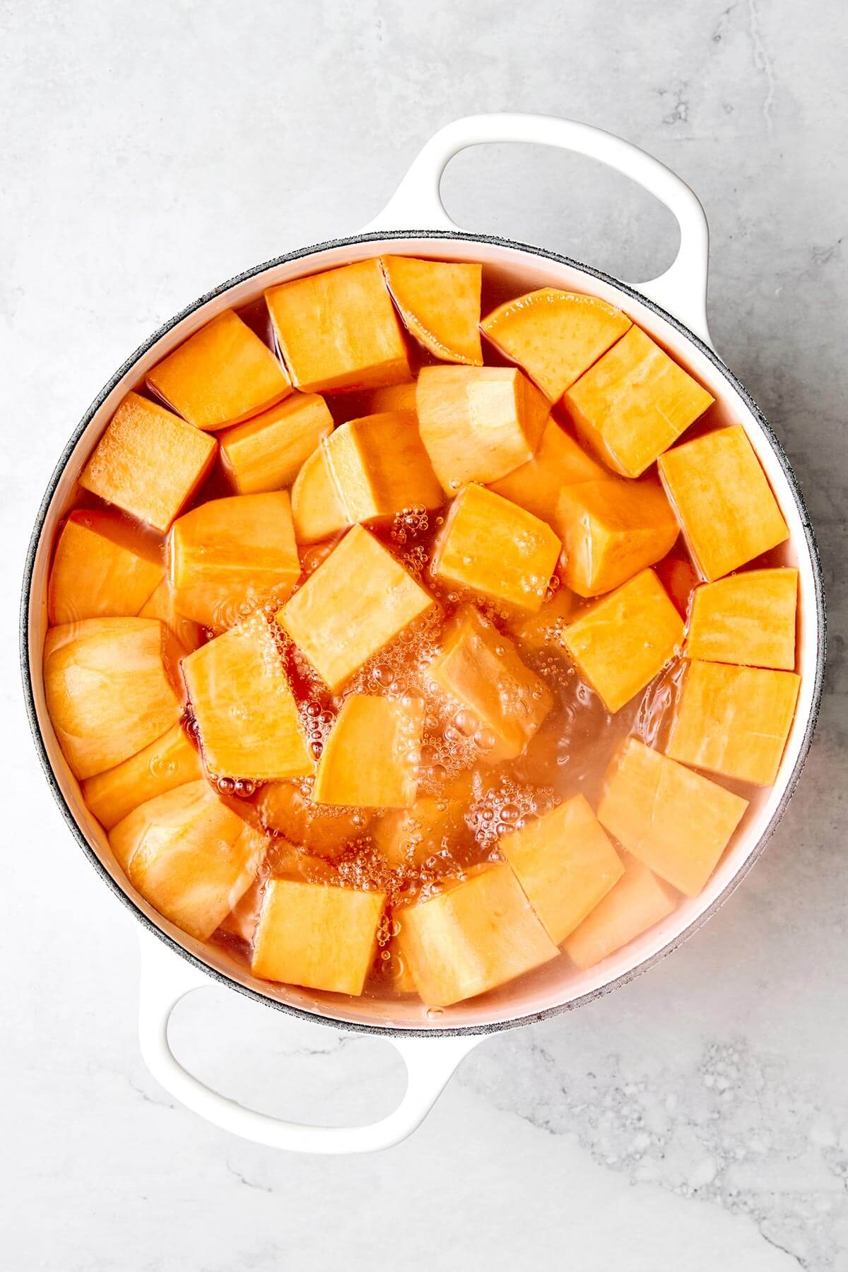 Boiling sweet potato in a pot.