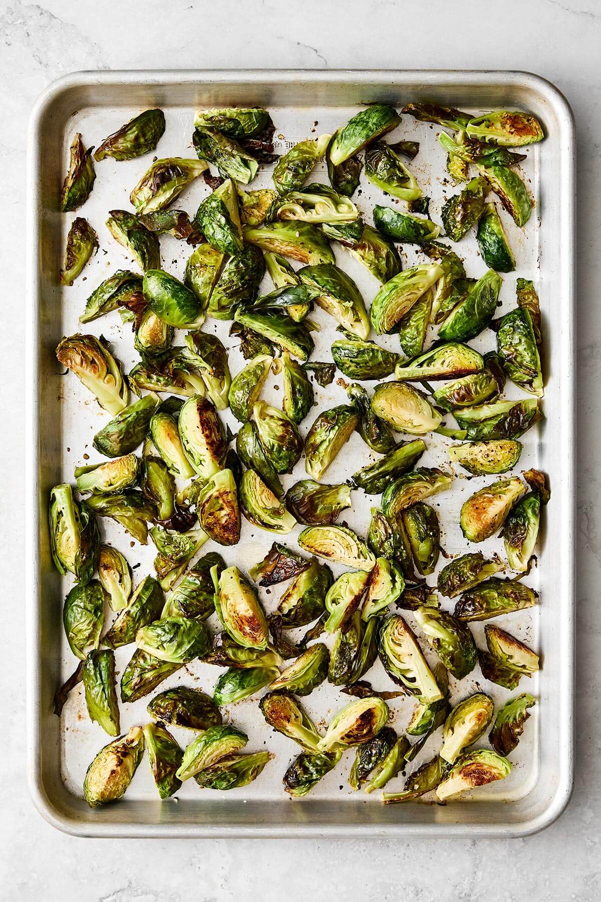 Roasted Brussels sprouts on a sheet pan.