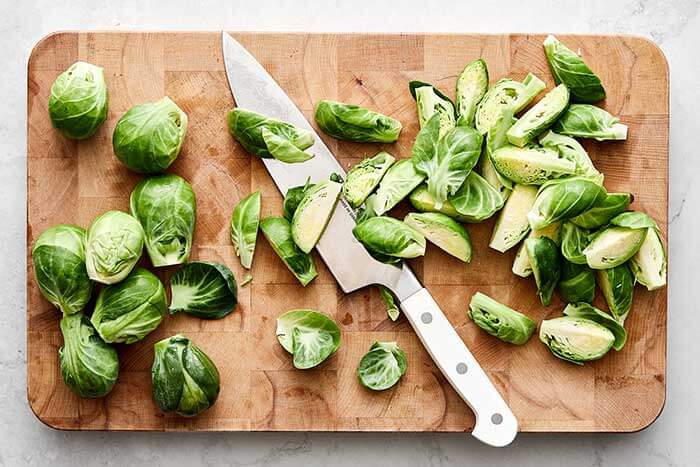 Sliced Brussels sprouts on a board.
