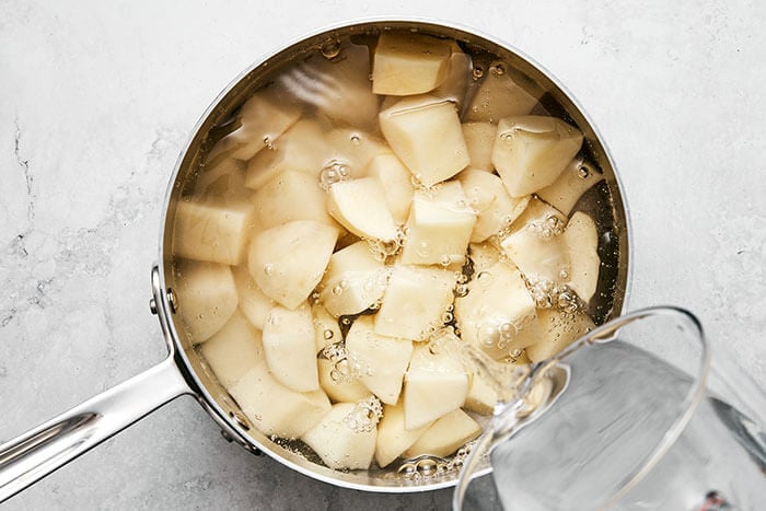 Boiling diced potatoes in a pot