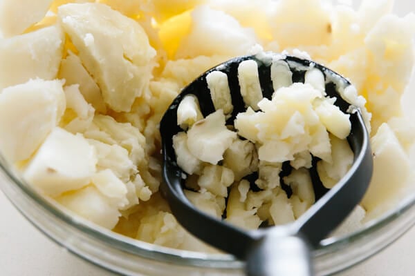 Mashing potatoes in a bowl.