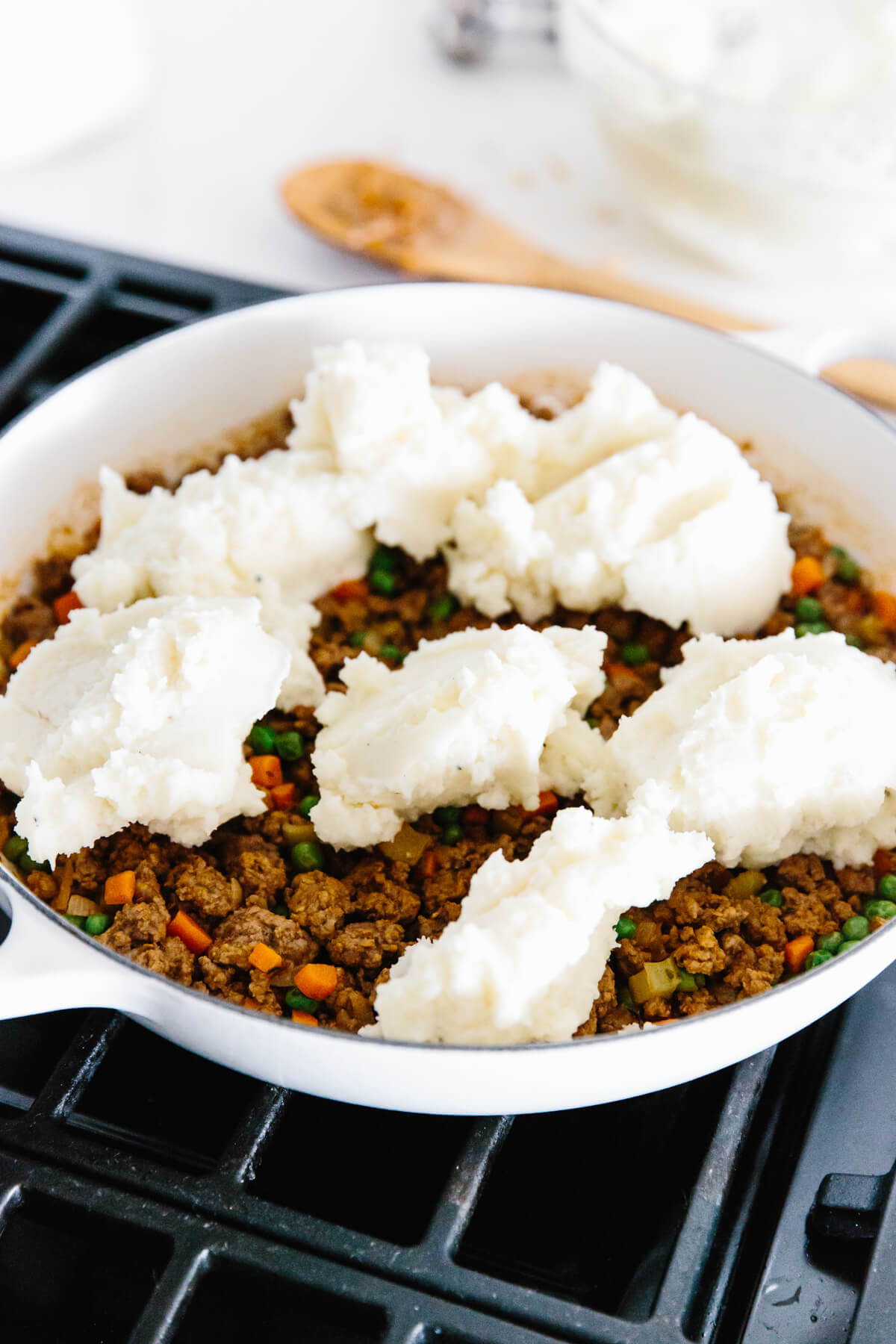 This easy shepherd's pie is a classic comfort food recipe that's heart, filling, and perfect for cozying up with in the fall, winter, and for St. Patrick's Day! Making Shepherd's pie and dolloping mashed potatoes on top.
