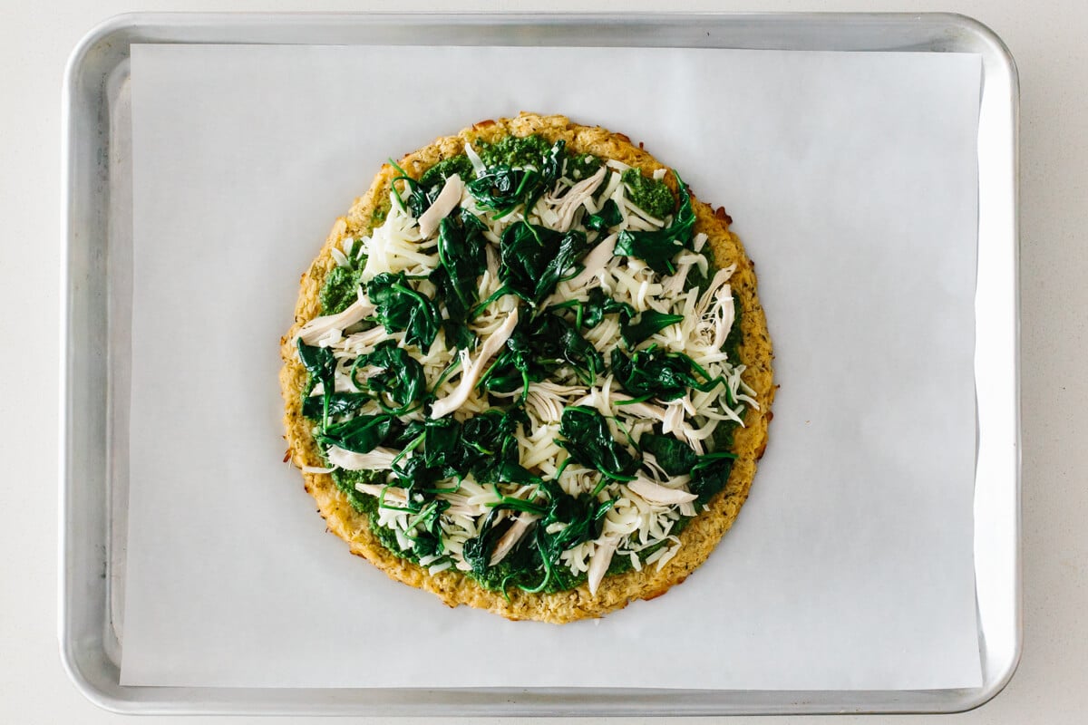 Making cauliflower pizza crust with toppings.