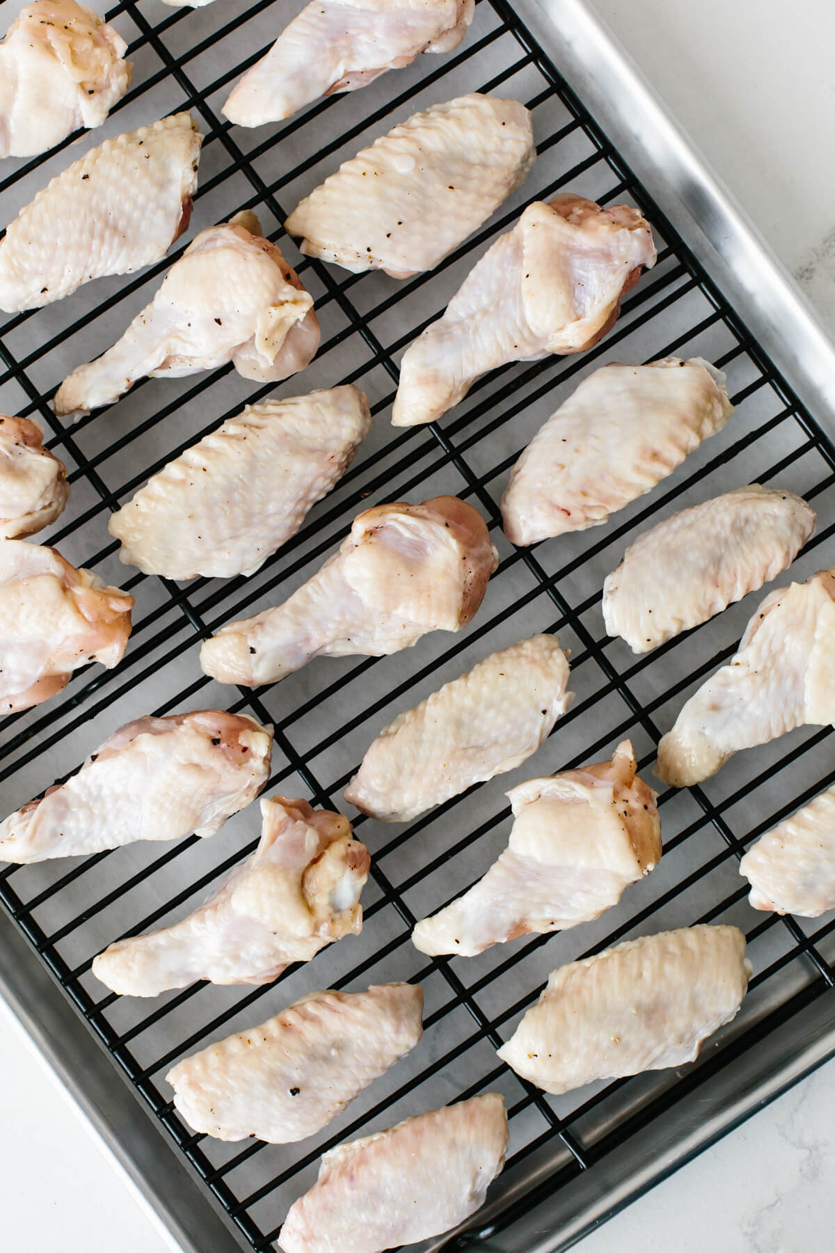 Chicken wings on a baking sheet.