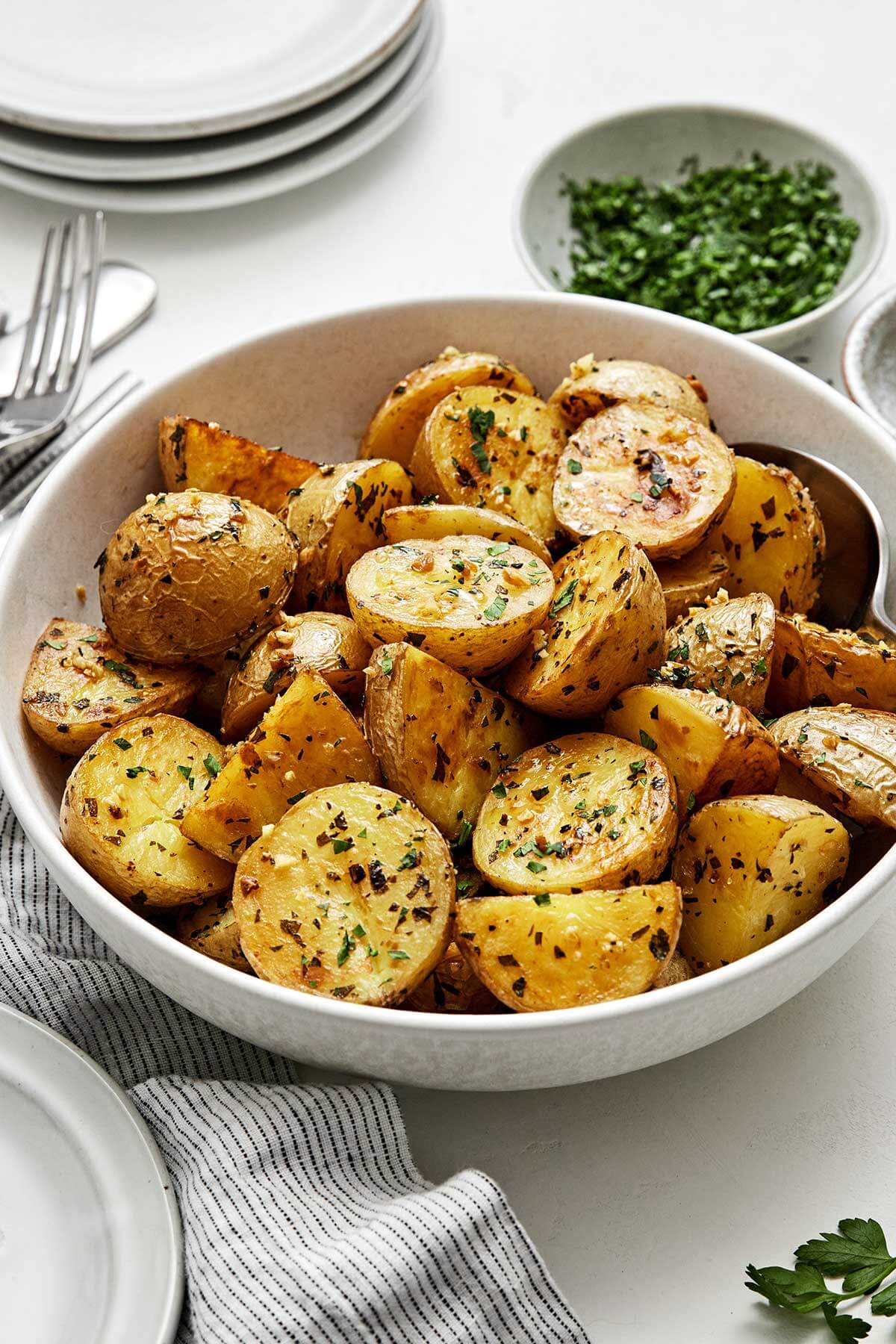 A bowl of garlic roasted potatoes.