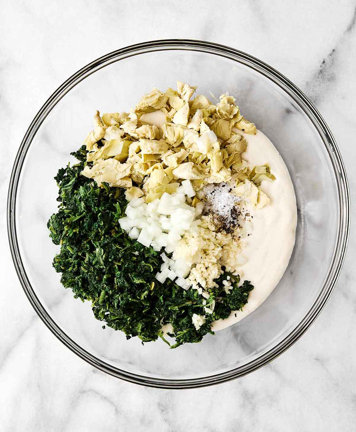 Step two of healthy spinach artichoke dip: mix everything together.