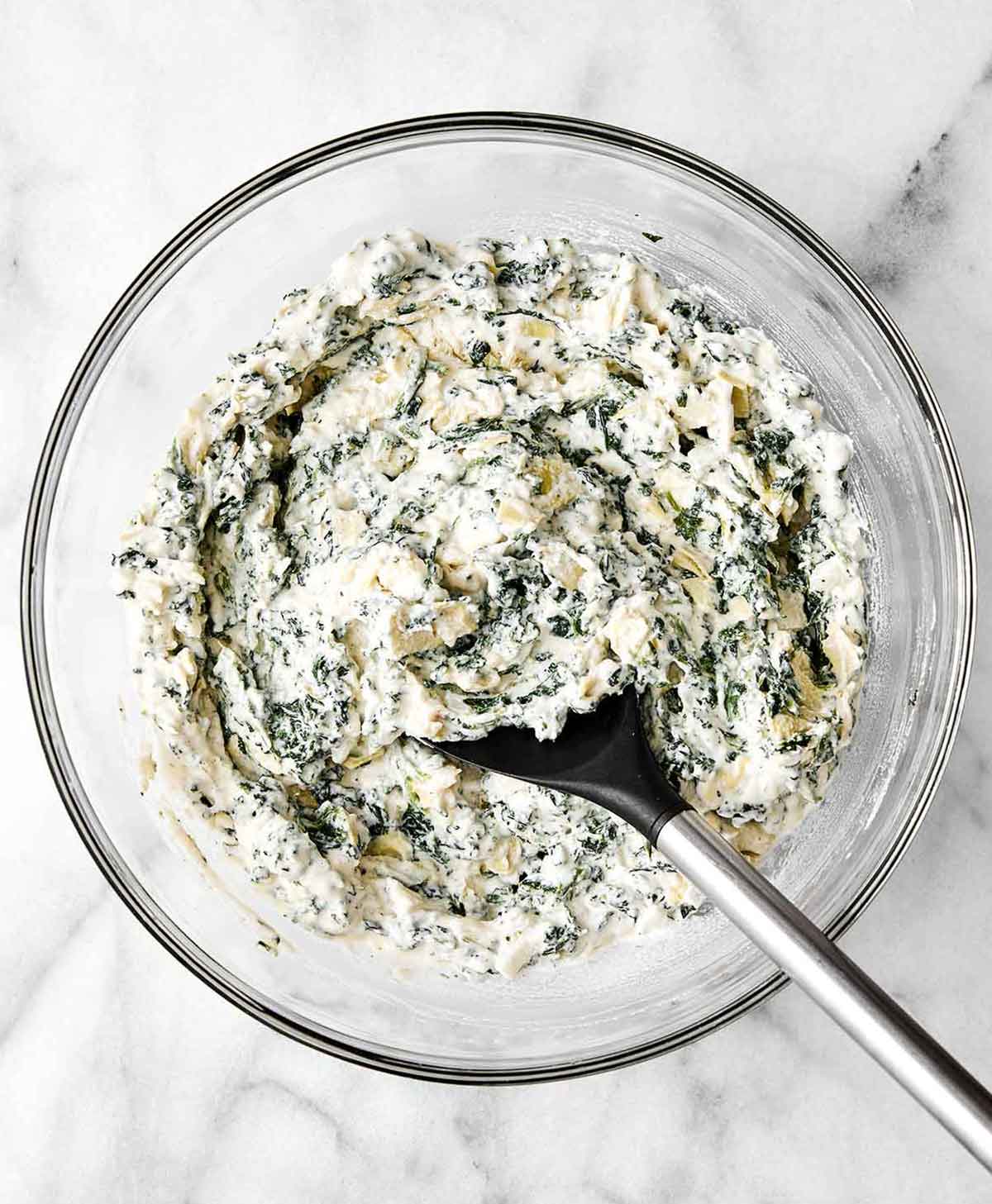 Step three of healthy spinach artichoke dip: bake in oven.